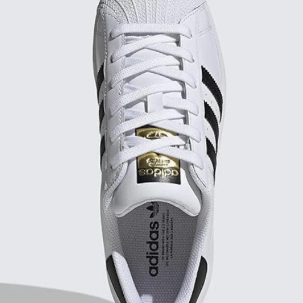 adidas Women’s White Sneakers with Black Stripes